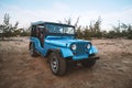 Restored retro car during the American Vietnam war on the sand in the desert of Vietnam