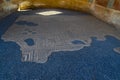 Restored Roman art floor mosaics and painted Roman art walls of the Theater House or Basilica House with sunlight streaming