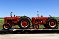 Restored W-6 and W-9 Farmall tractors loaded on a trailer