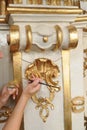 Restorer manually gilding listed interior