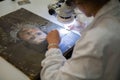 A Restorer who is Working on the Restoration of an Ancient Painting Royalty Free Stock Photo