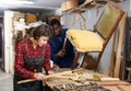 Restorers working with wooden furniture