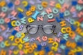 Restoring vision with the right glasses. Glasses and a blurred background of letters. The concept of healthy vision Royalty Free Stock Photo