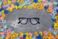 Restoring vision with the right glasses. Glasses and a blurred background of letters. The concept of healthy vision Royalty Free Stock Photo