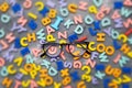 Restoring vision with the right glasses. Glasses and blurred background of letters. The concept of healthy vision Royalty Free Stock Photo
