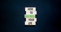 Restress your life symbol. Concept words How to restress your life on wooden blocks. Beautiful black table black background. Copy