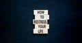 Restress your life symbol. Concept words How to restress your life on wooden blocks. Beautiful black table black background. Copy