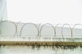 Restricted area with sky and sun, barbed bottom view and morning sun, Barbed wire fence and wire mesh with sky, Royalty Free Stock Photo