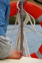 Restricted view from behind of a woman on the deck of a yacht Royalty Free Stock Photo