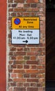 Restricted Zone Sign on The Red Brick Wall and No Loading Times Royalty Free Stock Photo