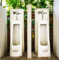 Restroom interior design with white urinal row