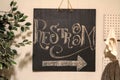 Restroom sign in coffee shop with retro lettering