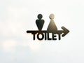 Restroom sign modern white color on light warm wall in public building. Royalty Free Stock Photo