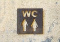 Restroom sign on stone wall Royalty Free Stock Photo