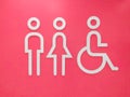 Restroom signs with a disabled access symbol on pink background Royalty Free Stock Photo