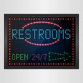 Restrooms sign with light neon shining on signboard