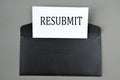 RESUBMIT - word on white paper on a black envelope with a magnifying glass Royalty Free Stock Photo