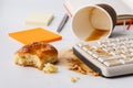Result of eating in office, Coffee and damaged computer keyboard close up Royalty Free Stock Photo