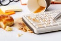 Result of eating in office, Coffee and damaged computer keyboard close up Royalty Free Stock Photo