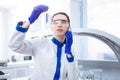 Occupied focused researcher viewing test tube