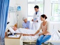 The results are in. a doctor delivering results to a sick man in a hospital bed and his family. Royalty Free Stock Photo