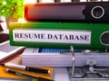 Resume Database on Green Ring Binder. Blurred, Toned Image.