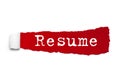 Resume word written under the curled piece of Red torn paper