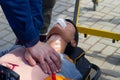Resuscitation of a training plastic doll on a medical gurney, indirect heart massage tutorial