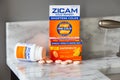 Retail box of Zicam zinc lozenges cold remedy, shown on bathroom counter.