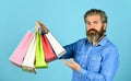 Retail concept. Happy holidays. Handsome buyer. Free shipping. Bearded man hold shopping bags. Seasonal sale. Hipster Royalty Free Stock Photo