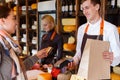 Customer paying for order of cheese in grocery shop. Royalty Free Stock Photo