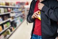 Retail Shoplifting. Man Stealing In Supermarket Royalty Free Stock Photo