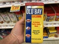 Retail store Spices hand holding Old Bay seasoning