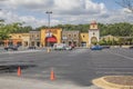 Retail strip mall Cars lined up outdoor curb event security officer pandemic 2020