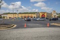 Retail strip mall Cars lined up outdoor curb event security officer traffic during the coronavirus pandemic