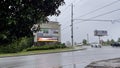 retail strip malls signs rain traffic overcast sky