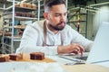 Retail trade concept , man owner of food factory using devices for online business order at bakehouse Royalty Free Stock Photo
