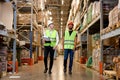 Retail Warehouse full of Shelves with Goods, Young Workers Supervisors Discuss Product Delivery