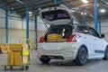 Retailer loading cardboard box into car trunk in warehouse, Package Distribution, Logistics, Delivery concept Royalty Free Stock Photo