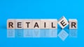 Retailer - words from wooden blocks with letters, distributive trades retail concept, blue background Royalty Free Stock Photo