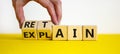 Retain or explain symbol. Businessman turns wooden cubes and changes the word explain to retain. Beautiful yellow table, white