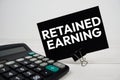 Retained Earning text message with calculate on wooden background Royalty Free Stock Photo