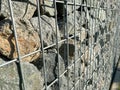 Retaining wall gabion baskets, Gabion wall caged stones textured background. Gabion wall caged stones Royalty Free Stock Photo