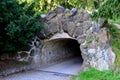 Retaining wall made of coarse basalt stones connected by cement. tunnel under the pedestrian road. the underpass is a historical r Royalty Free Stock Photo