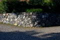 Retaining wall made of coarse basalt stones connected by cement. tunnel under the pedestrian road. the underpass is a historical r Royalty Free Stock Photo