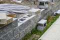 Retaining wall project in a residential house build, sidewalk, blocks, plastic, and dirt, work in progress