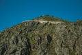 Retaining wall of road passing through rocky landscape Royalty Free Stock Photo