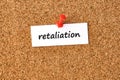 Retaliation. Word written on a piece of paper, cork board background Royalty Free Stock Photo