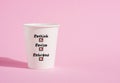 Rethink, revise and rebrand on a paper coffee cup on pink background