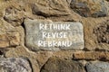 Rethink revise rebrand symbol. Concept word Rethink Revise Rebrand on beautiful big stone. Beautiful stone wall background.